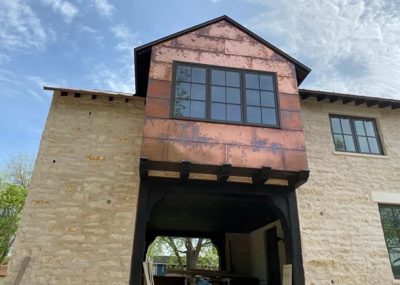 Copper metal panel facade on a stone building for Metal Roof Coating in Lamesa